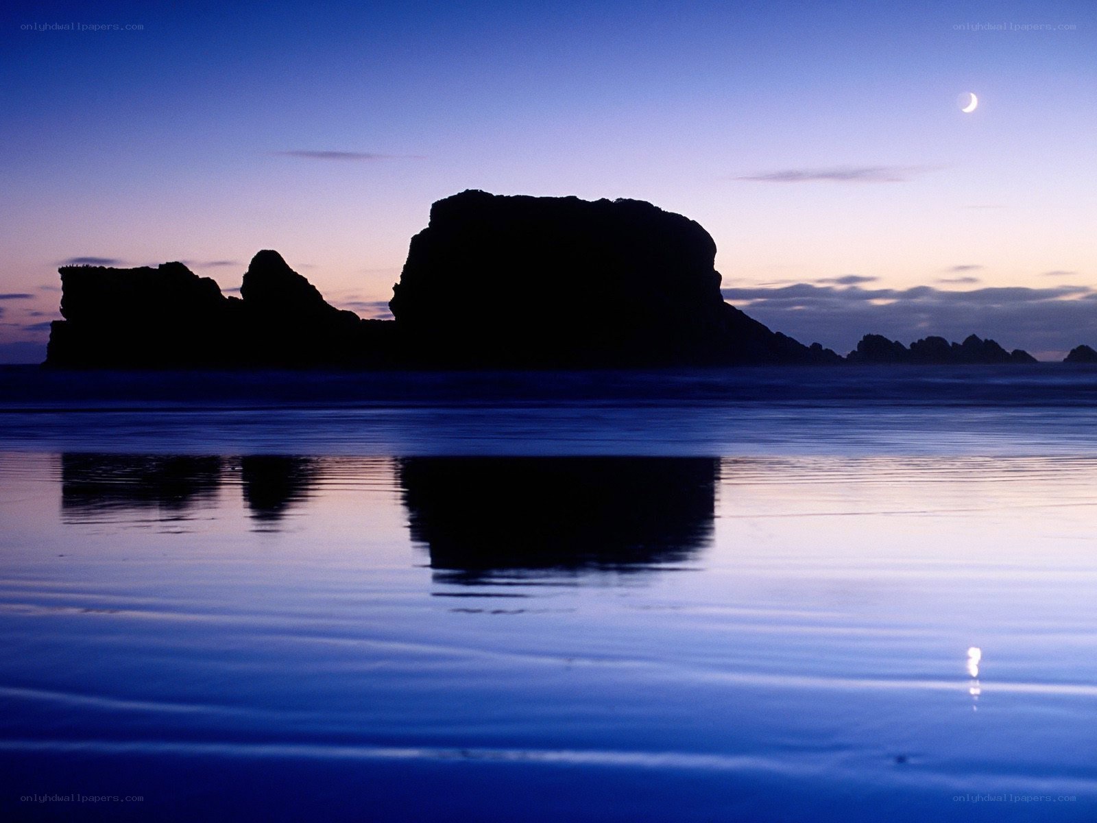 Moonlit rocks at twilight