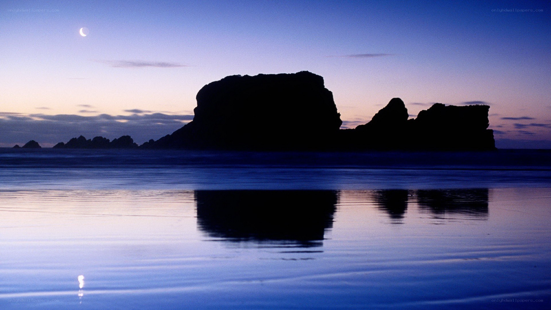 Moonlit rocks at twilight