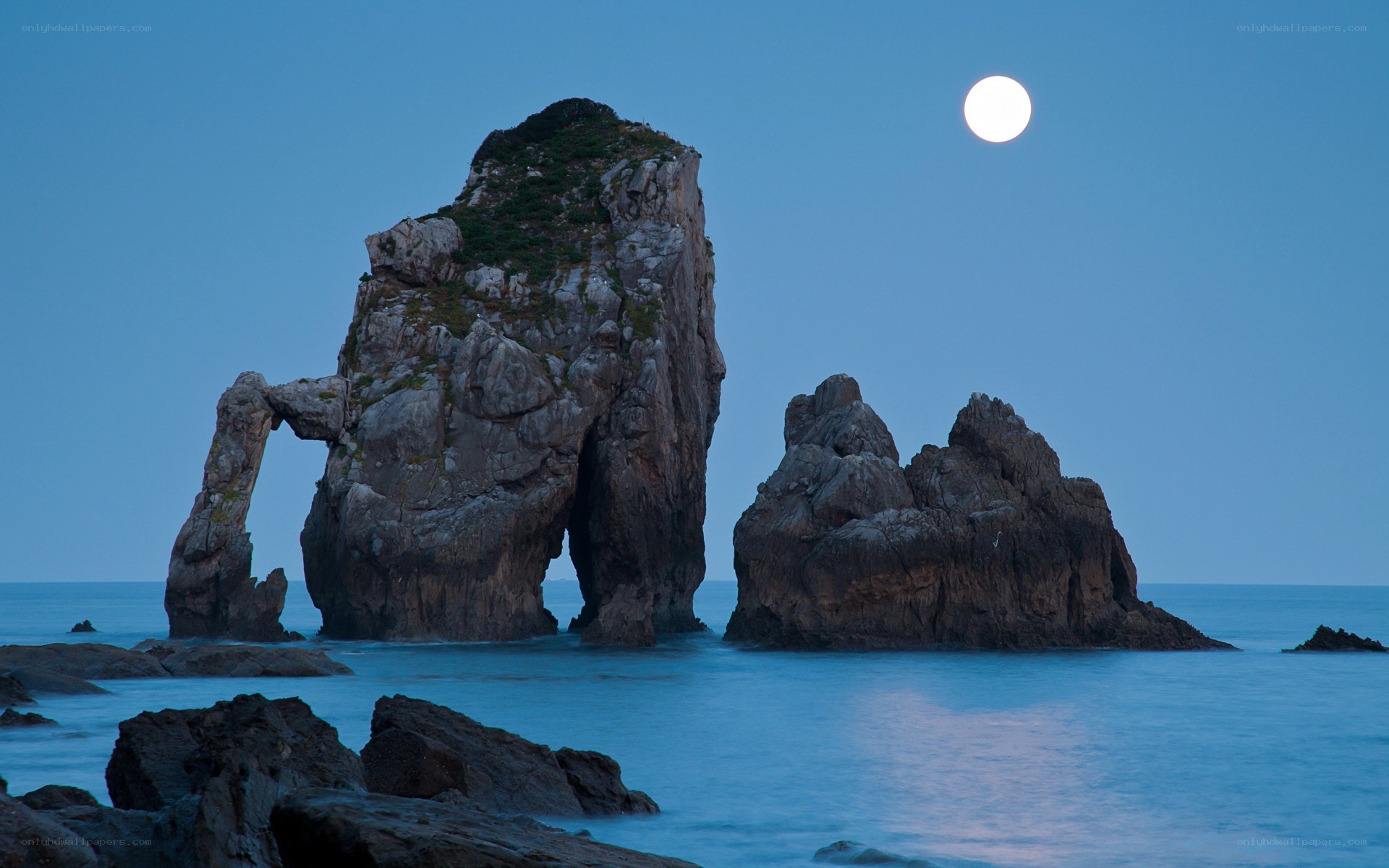 Moonlit sea arch at dusk