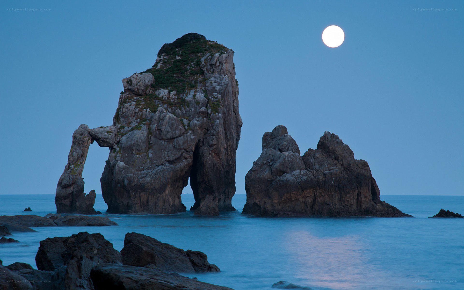 Moonlit sea arch at dusk