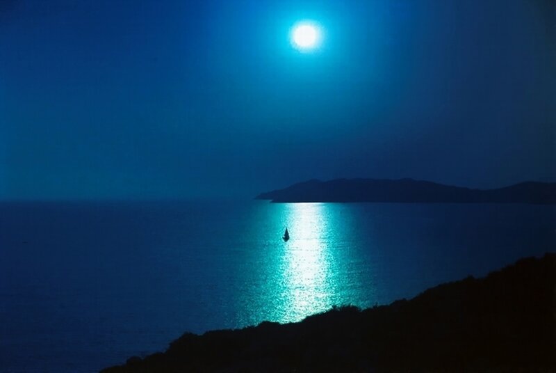 Moonlit sea with sailboat