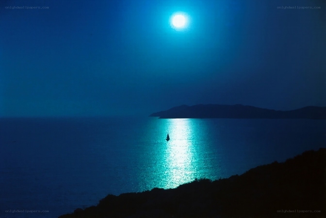 Moonlit sea with sailboat