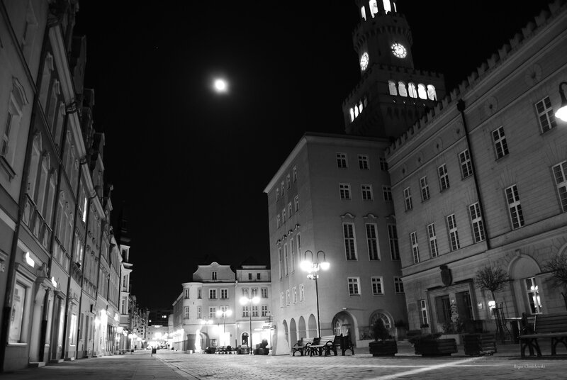 Moonlit town square at night