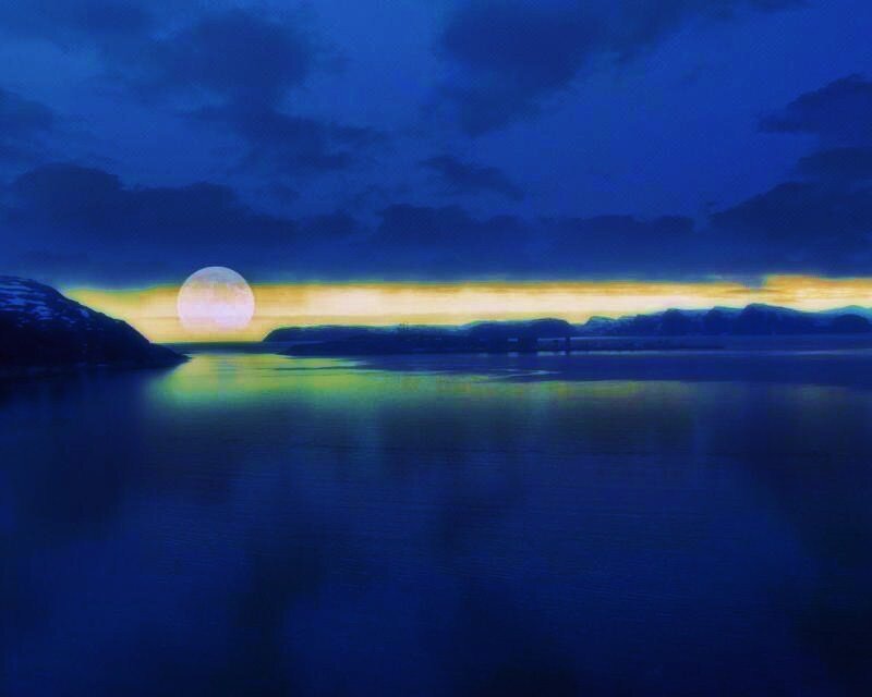 Moonrise over a calm bay