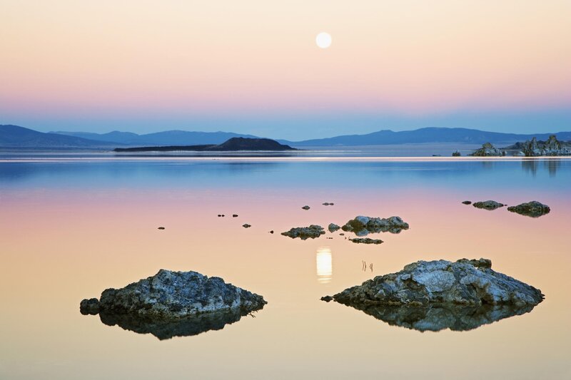 Moonrise over a calm lake