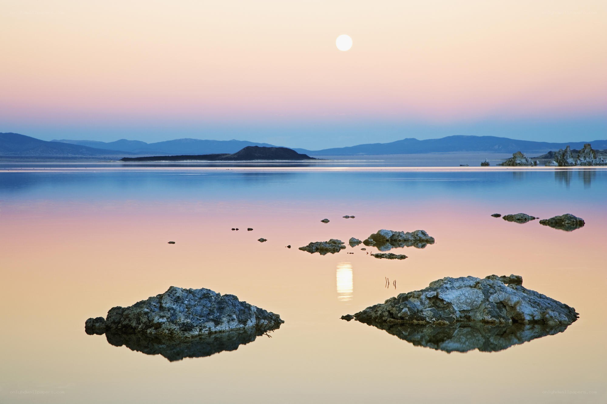 Moonrise over a calm lake