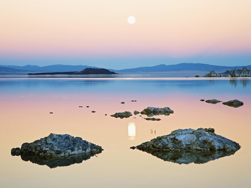 Moonrise over a calm lake
