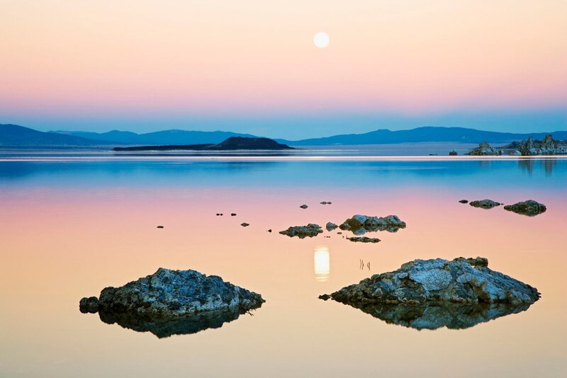 Moonrise over a calm lake