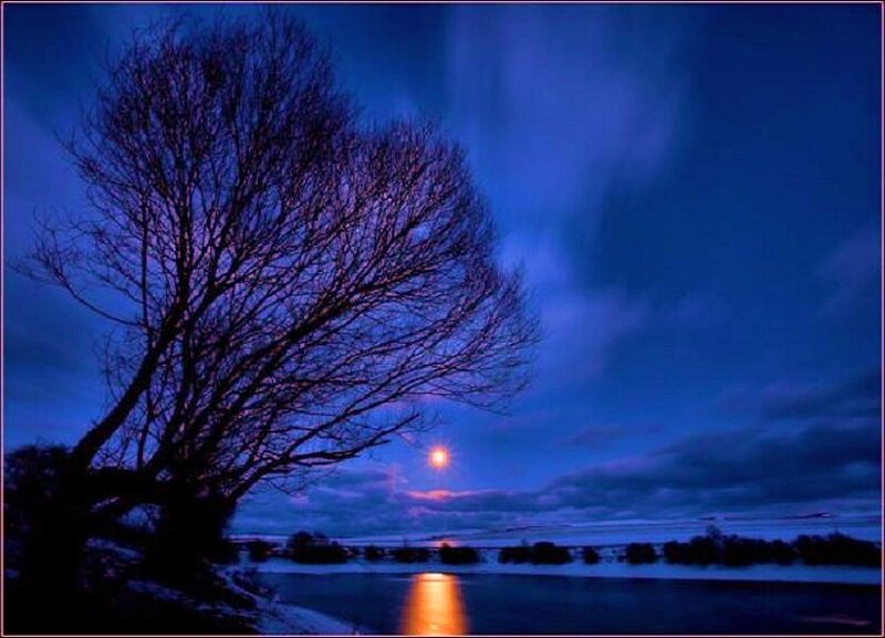 Moonrise over a frozen river