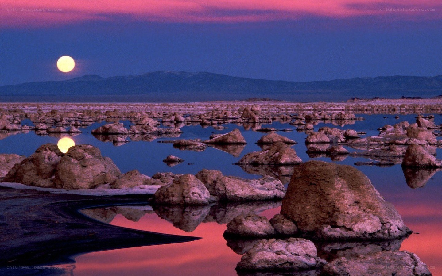 Moonrise over a salt flat