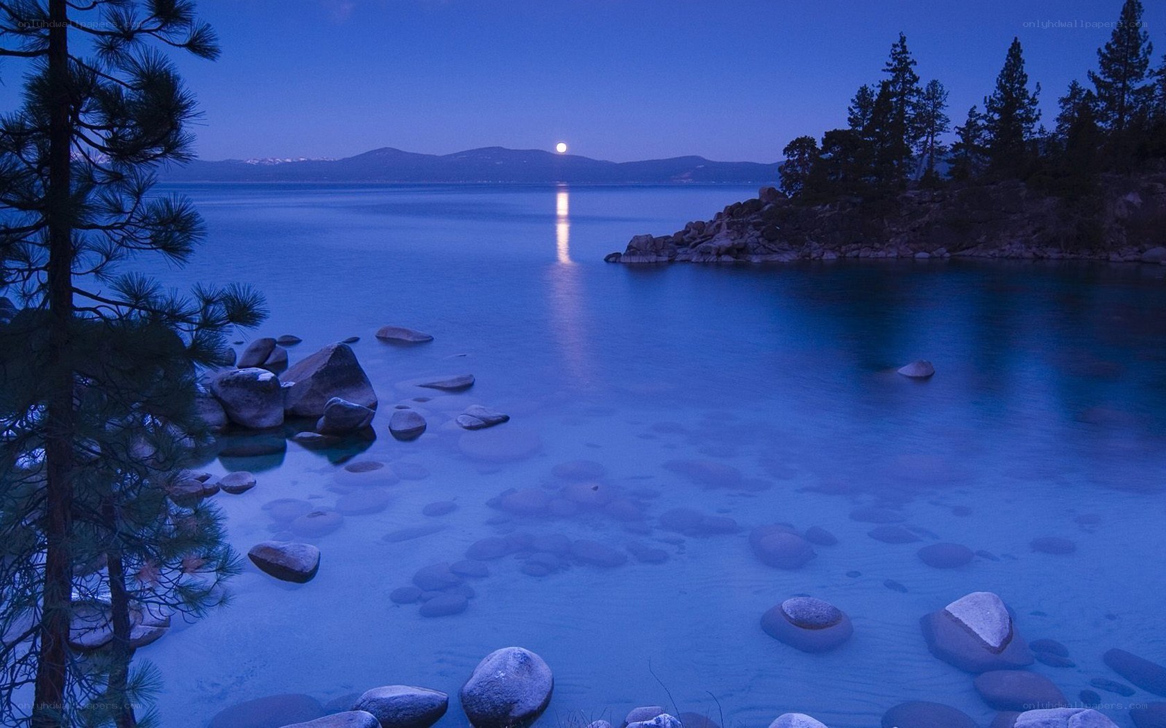 Moonrise over a serene lake