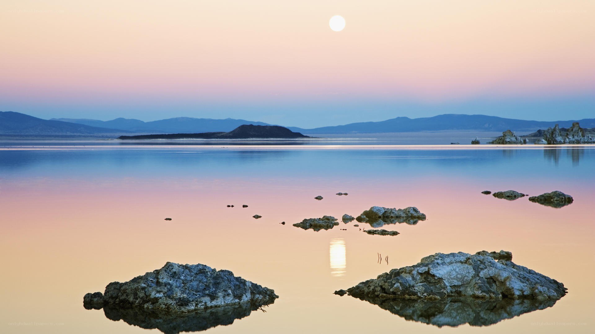 Moonrise over calm lake