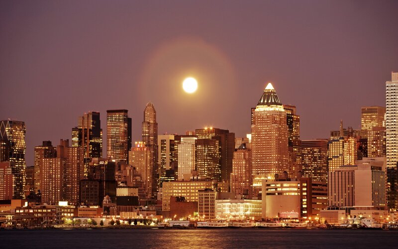 Moonrise over city skyline