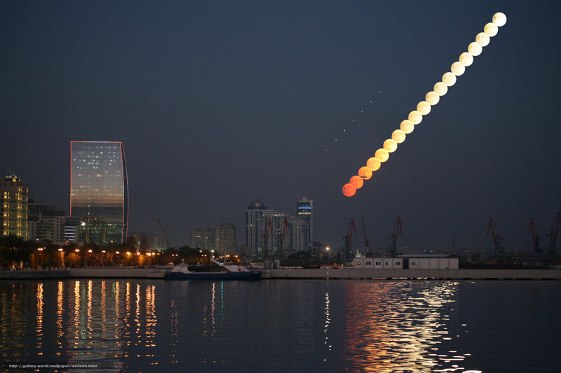 Moonrise over city skyline