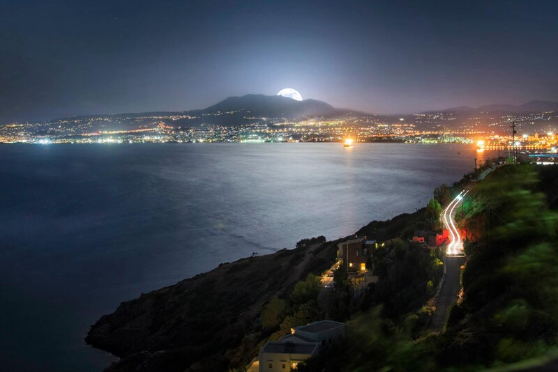 Moonrise over coastal city