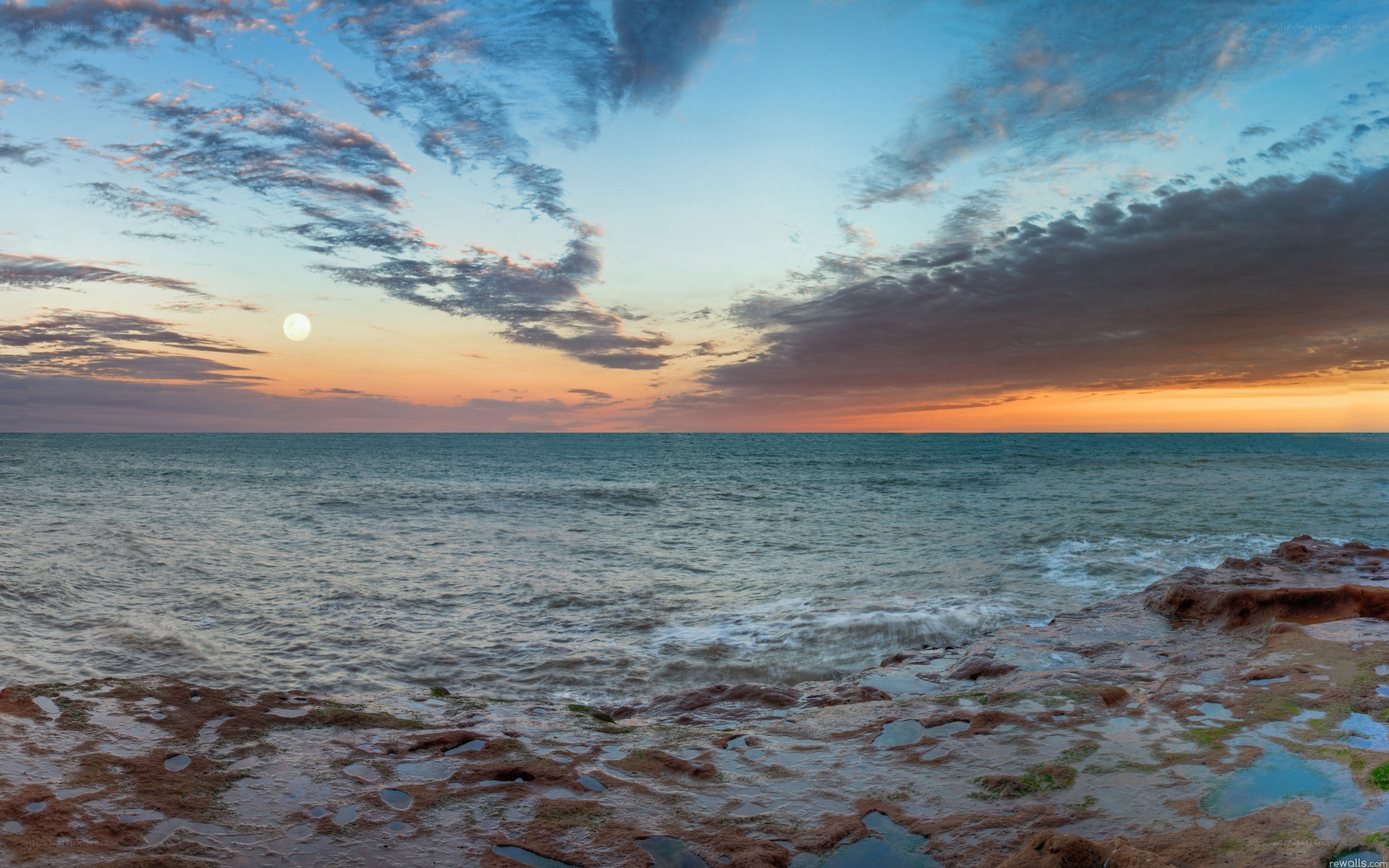 Moonrise over coastal rocks