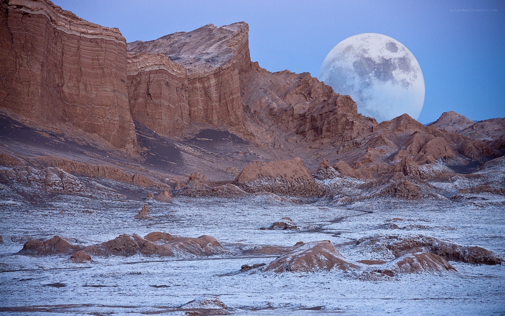 Moonrise over desert canyon