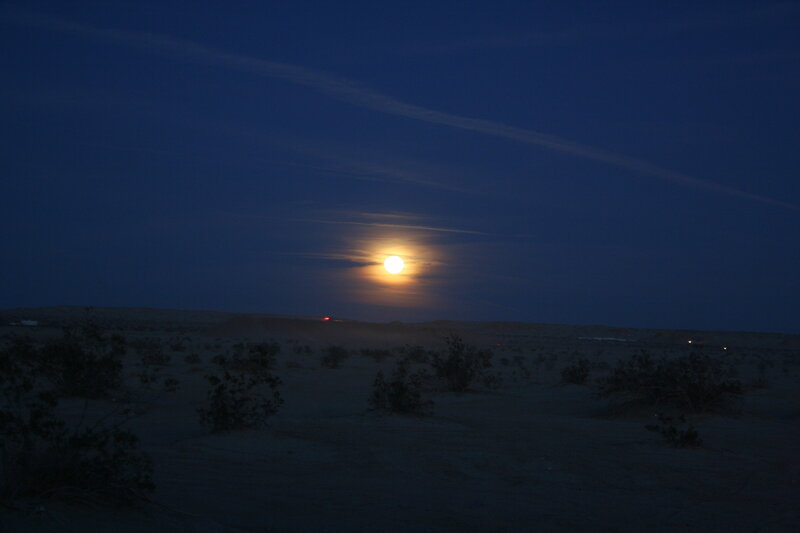 Moonrise over desert landscape