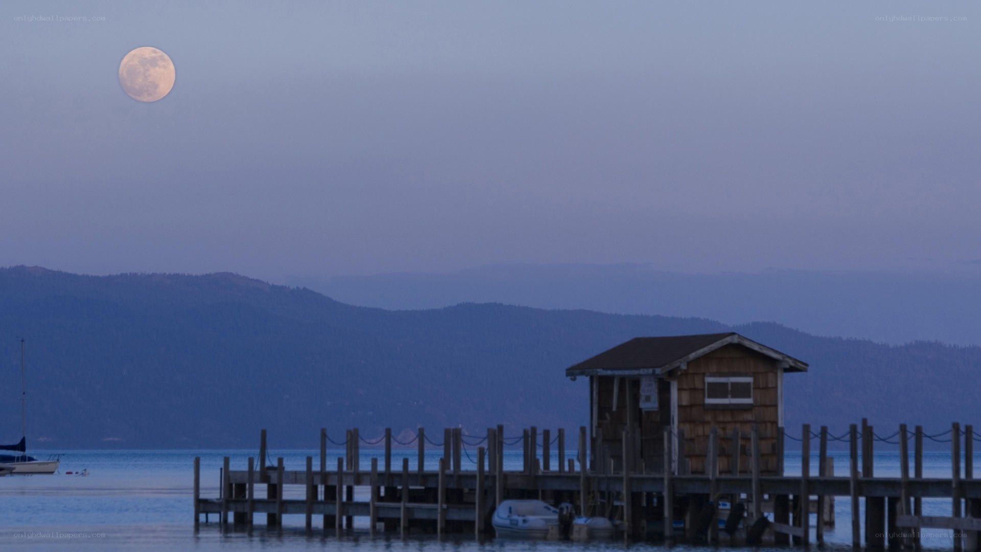 Moonrise over lake dock