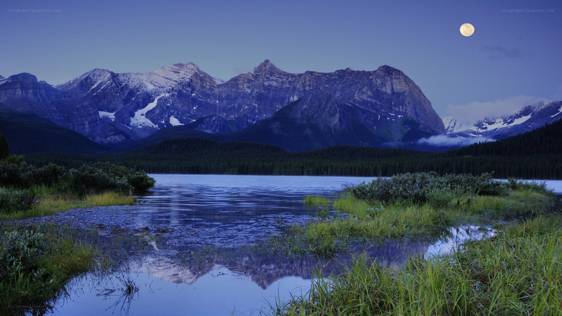 Moonrise over mountain lake