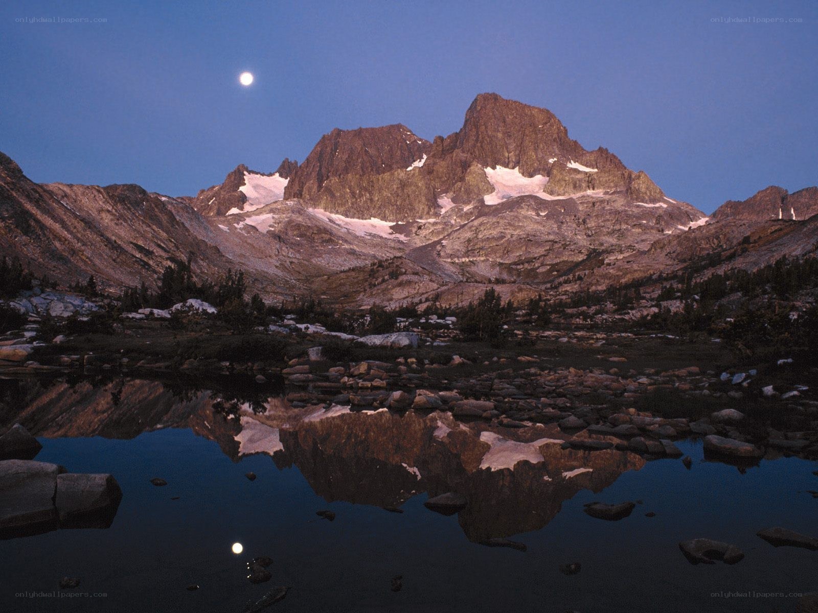 Moonrise over mountain lake