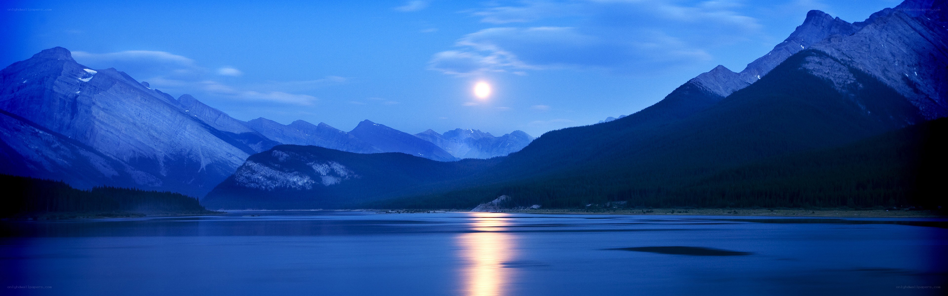 Moonrise over mountain lake