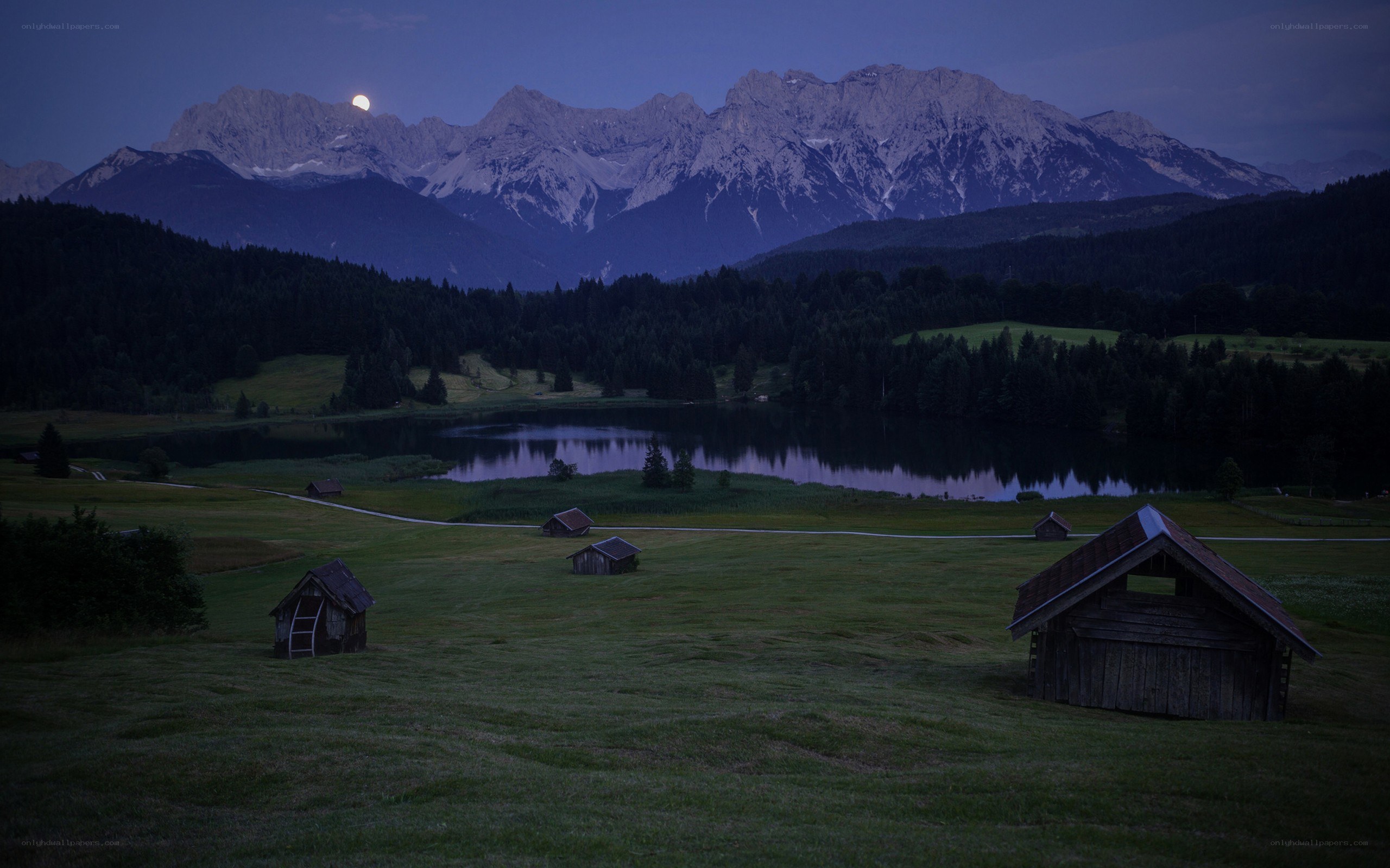 Moonrise over mountain lake