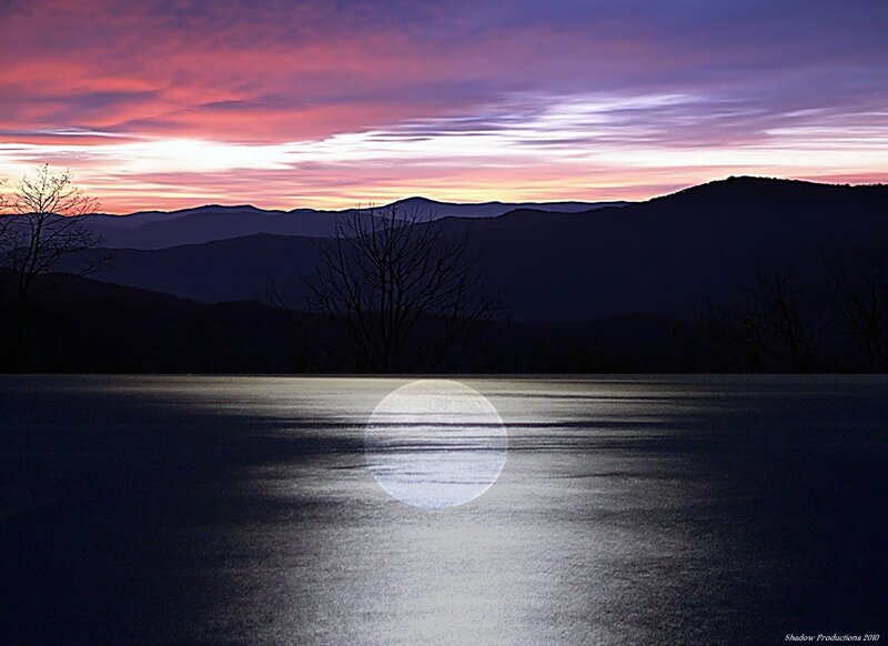 Moonrise over mountain lake