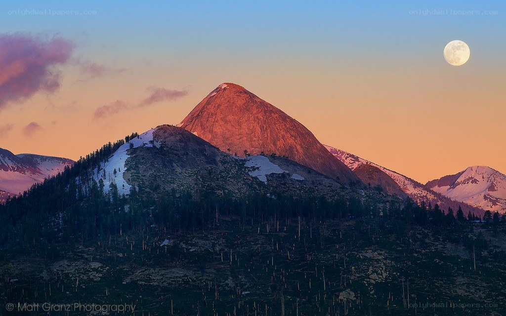 Moonrise over mountain peak