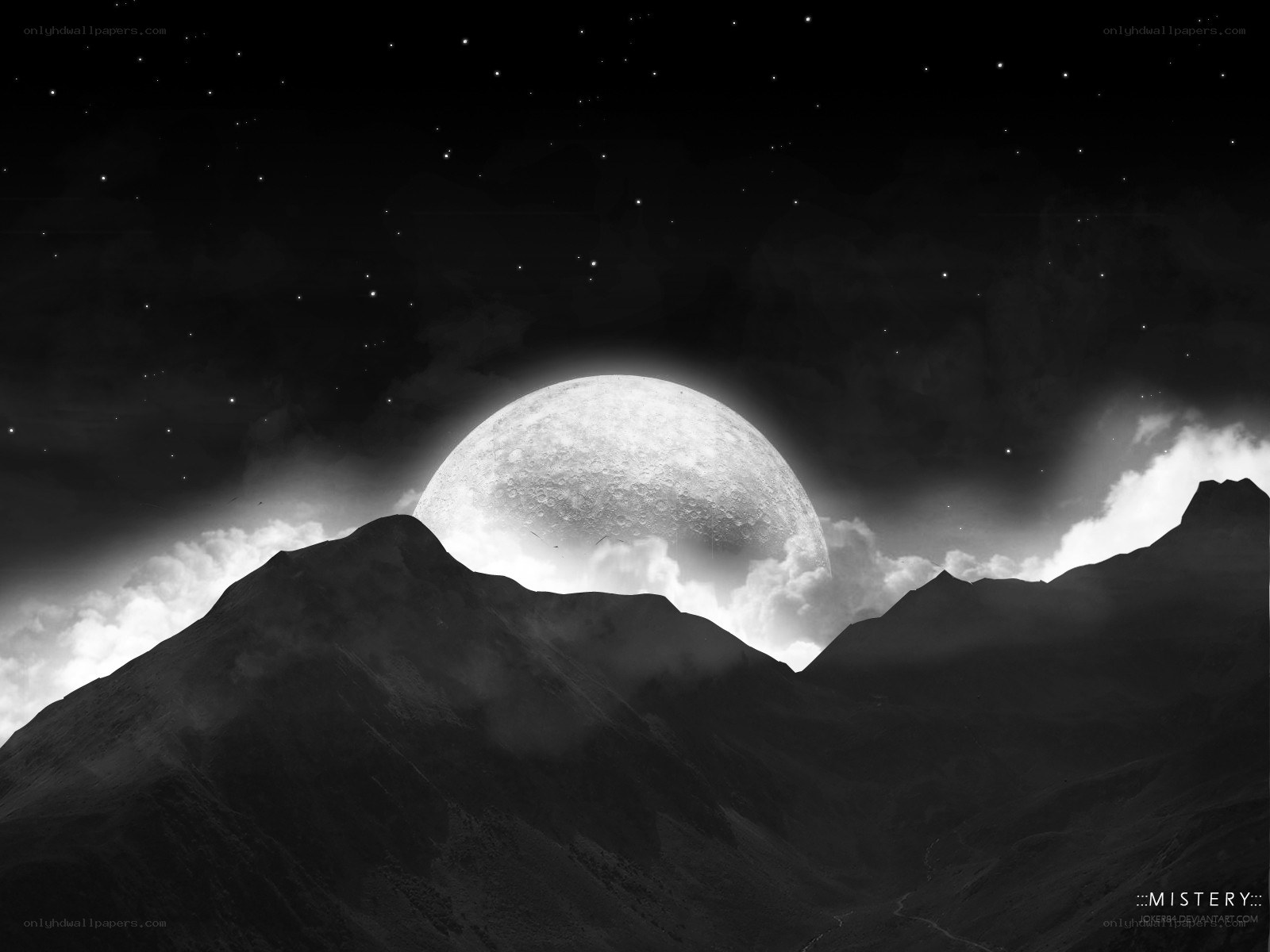 Moonrise over mountain peaks