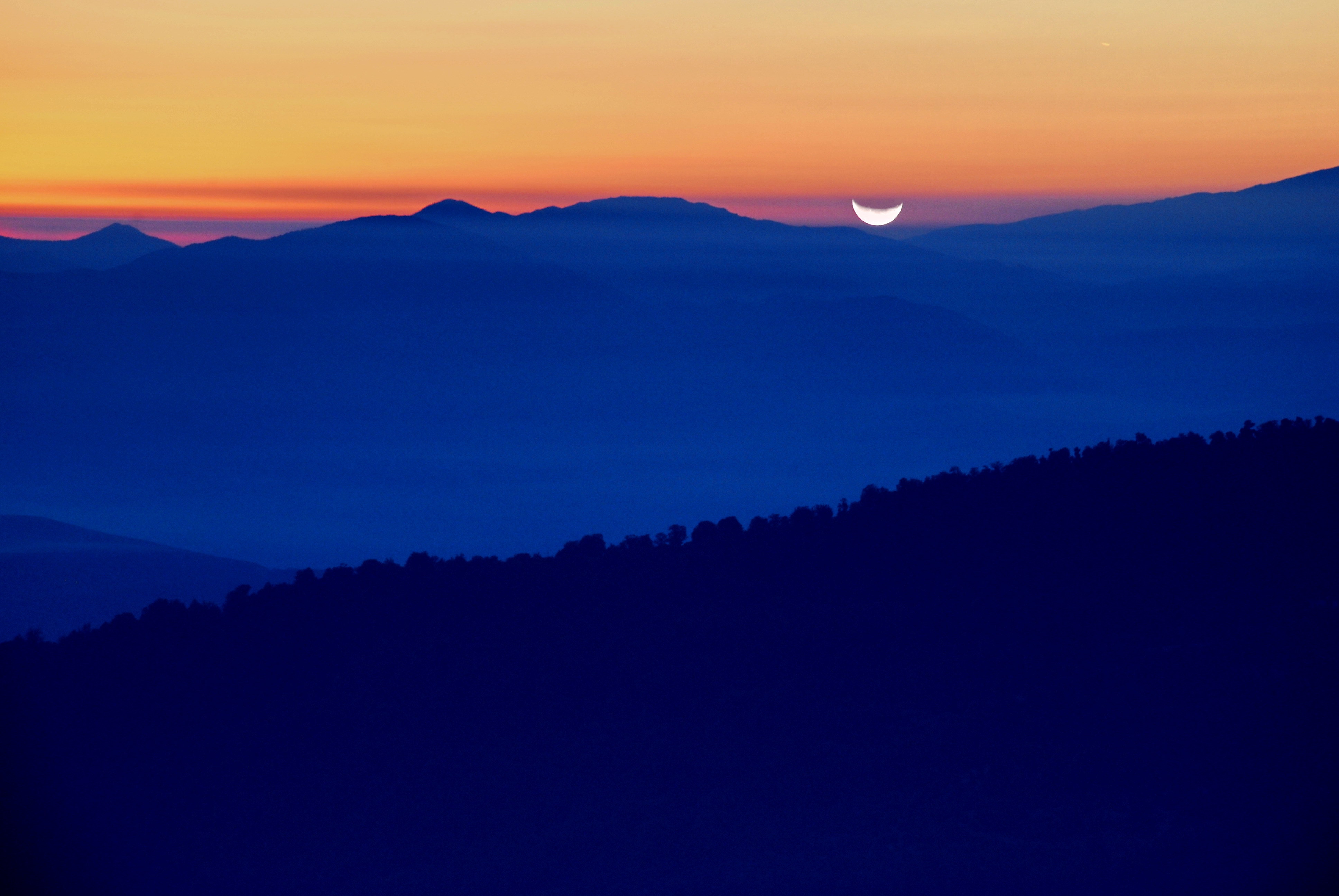 Moonrise over mountain ridges