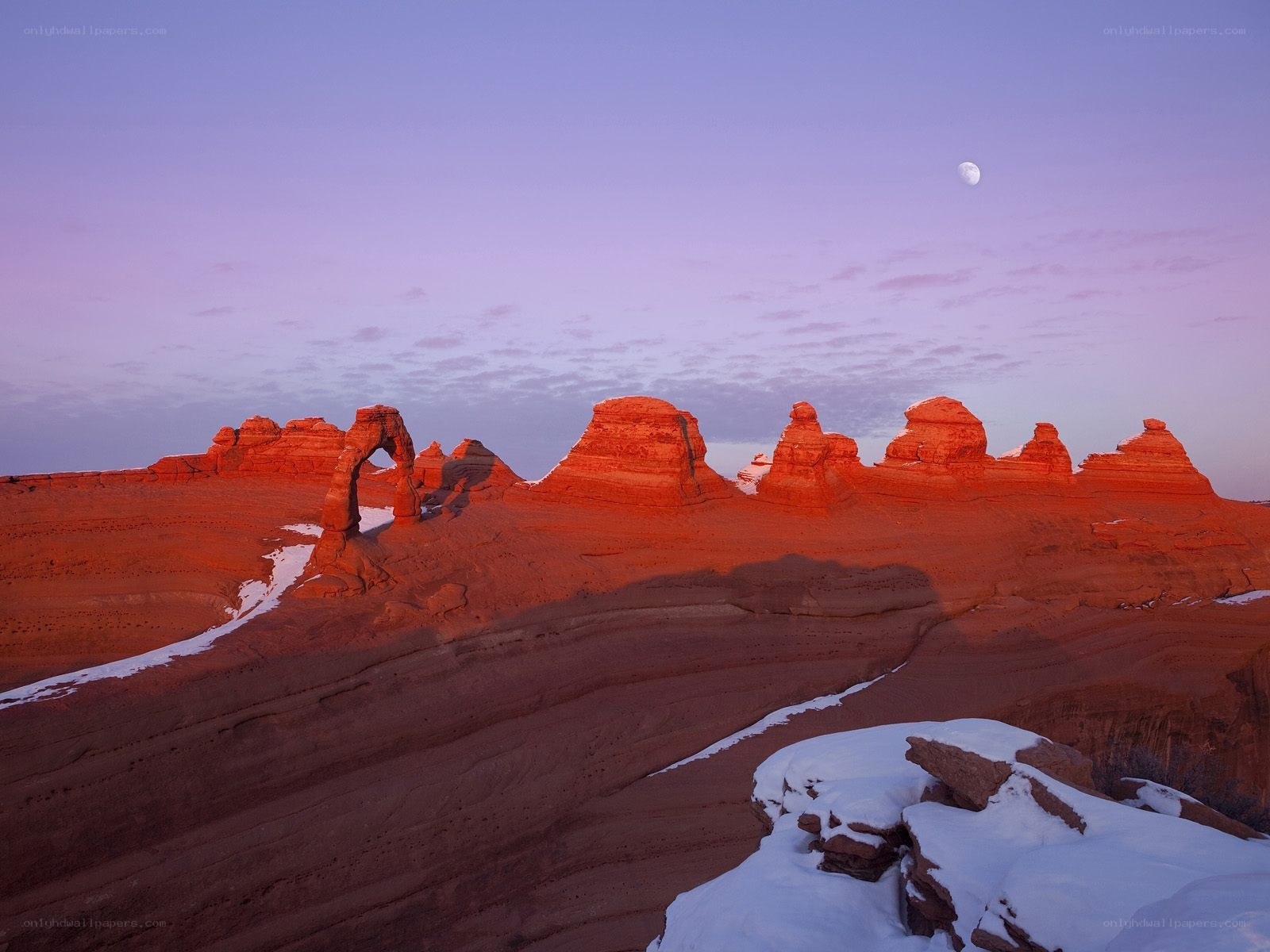 Moonrise over red rock arches