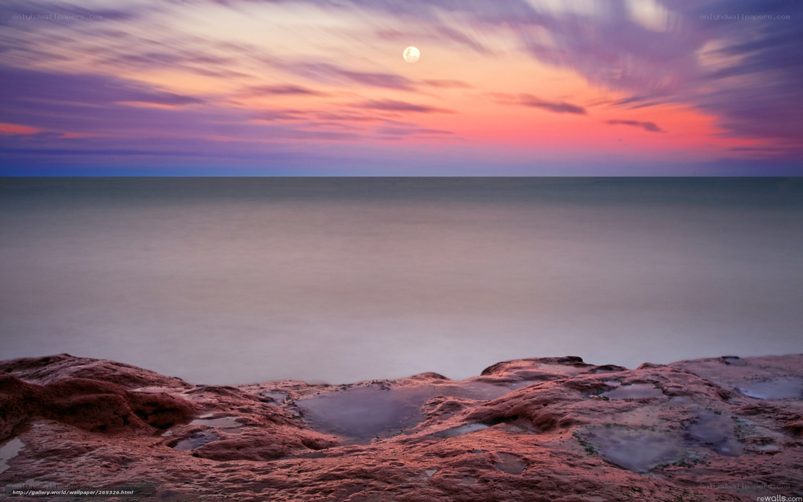 Moonrise over rocky shore