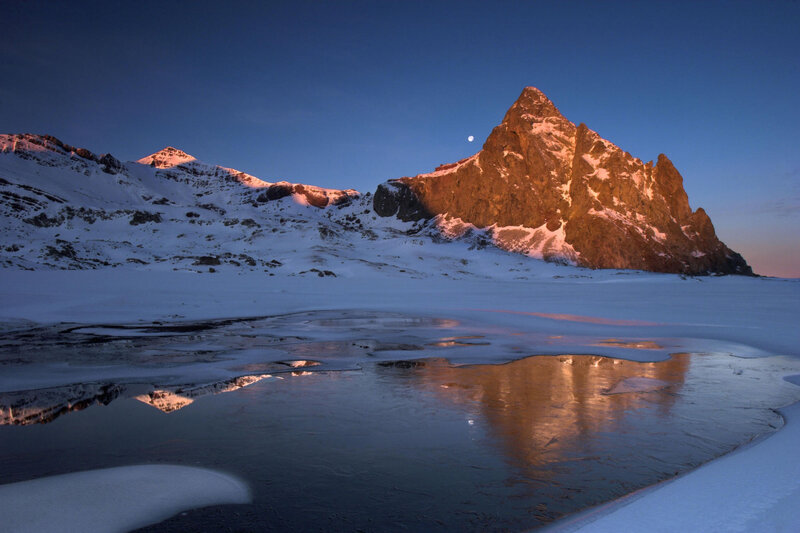 Moonrise over snowy mountains