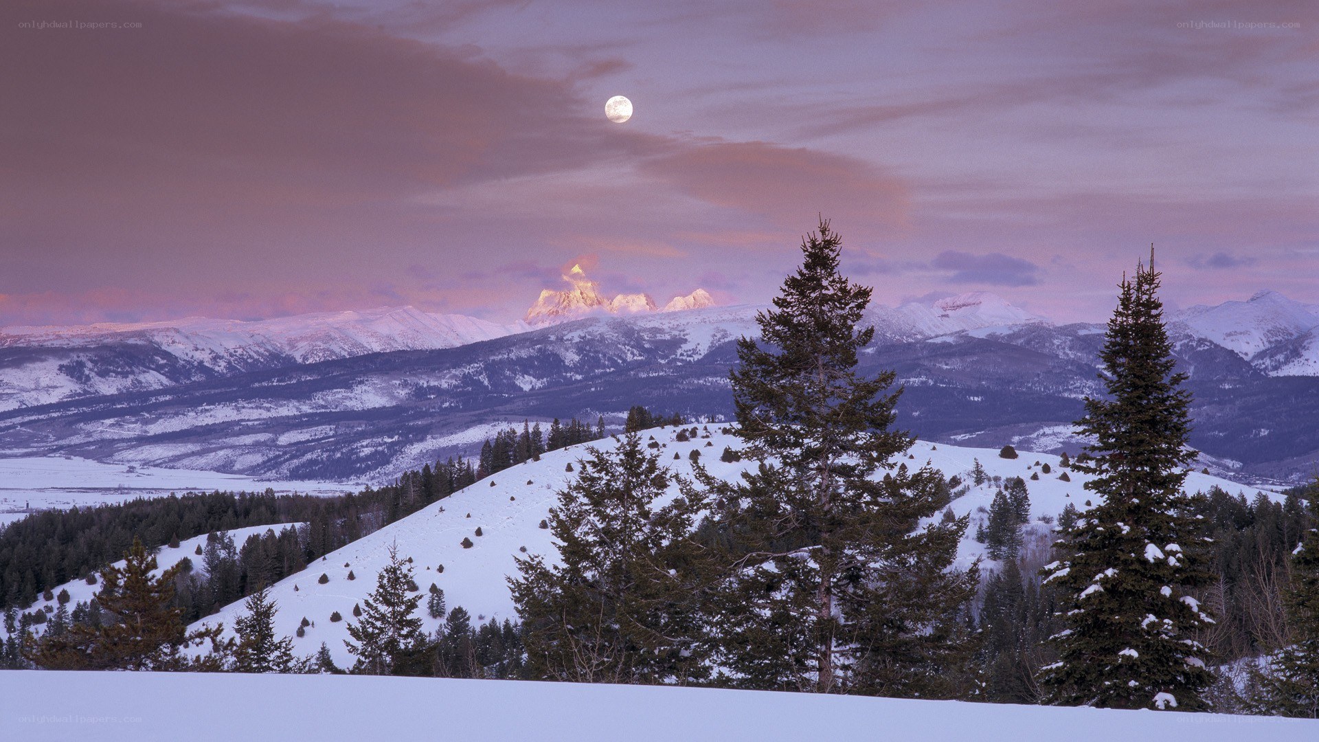 Moonrise over snowy mountains