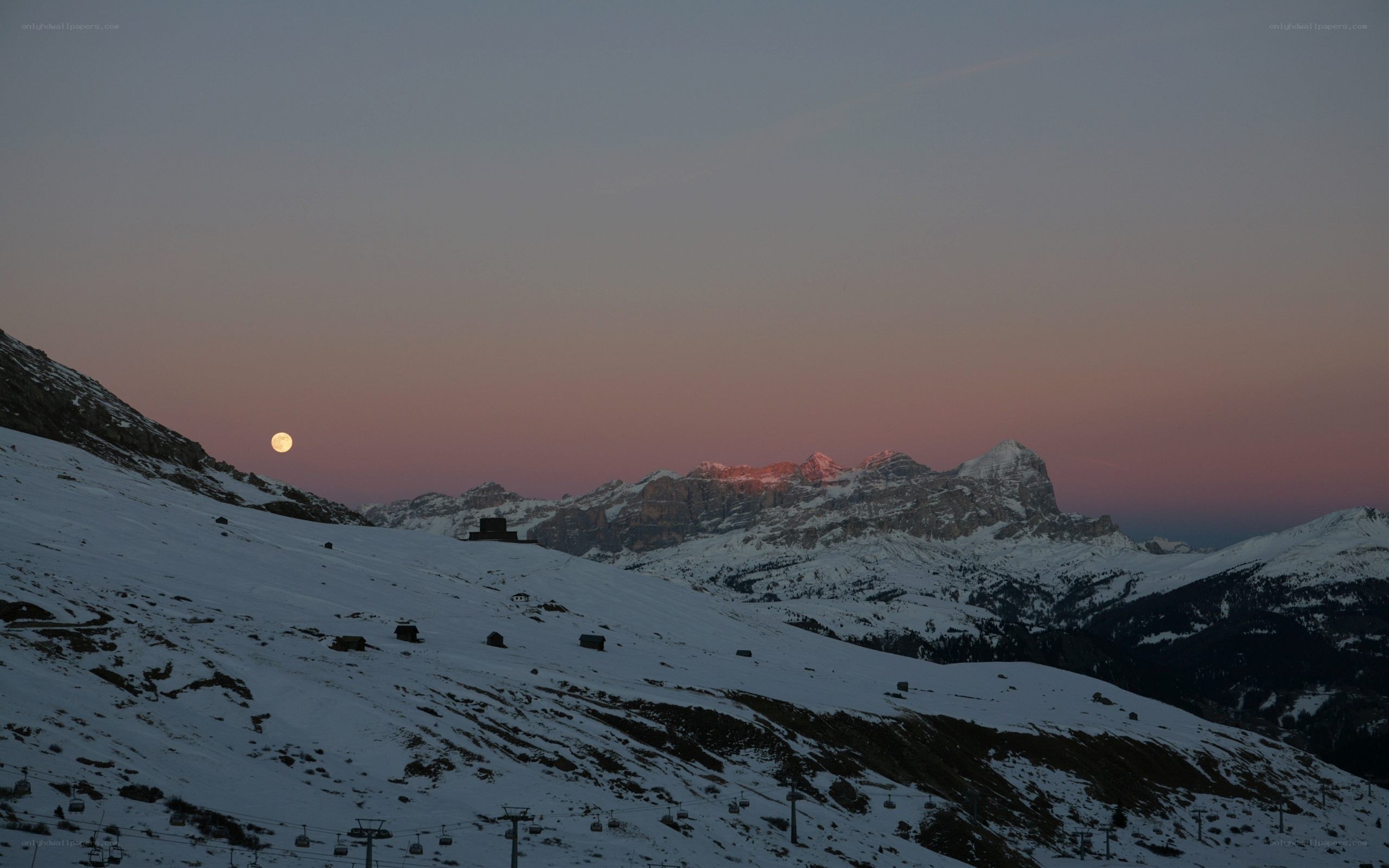 Moonrise over snowy mountains