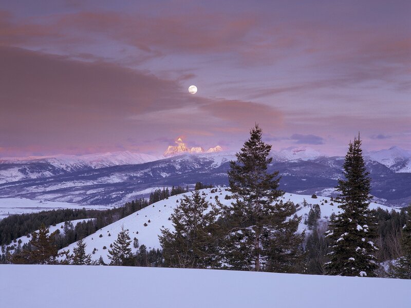Moonrise over snowy mountains