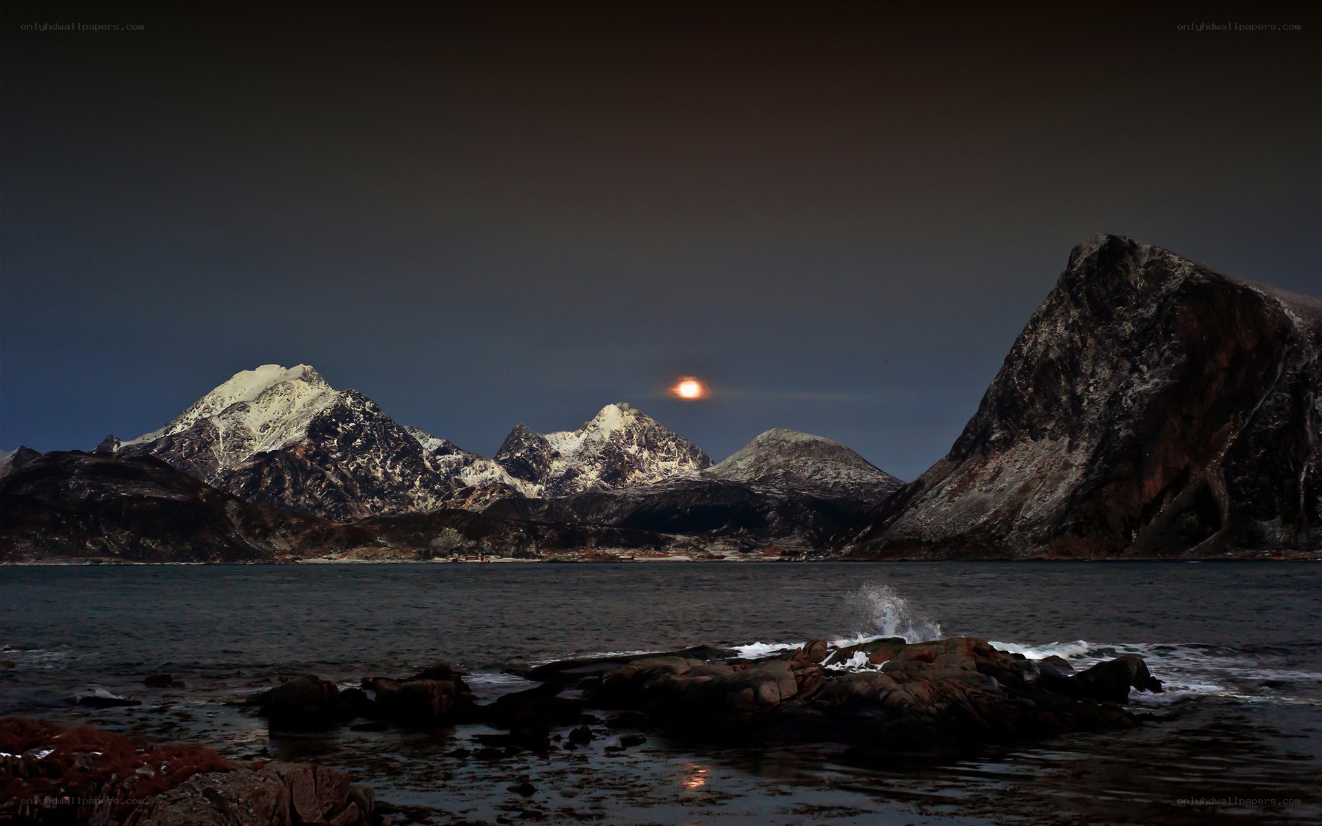 Moonrise over snowy mountains