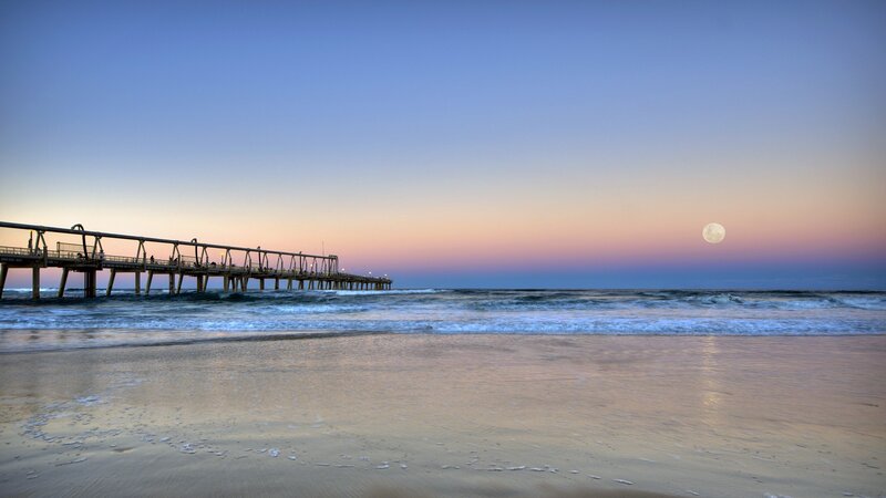 Moonrise over the pier at dusk