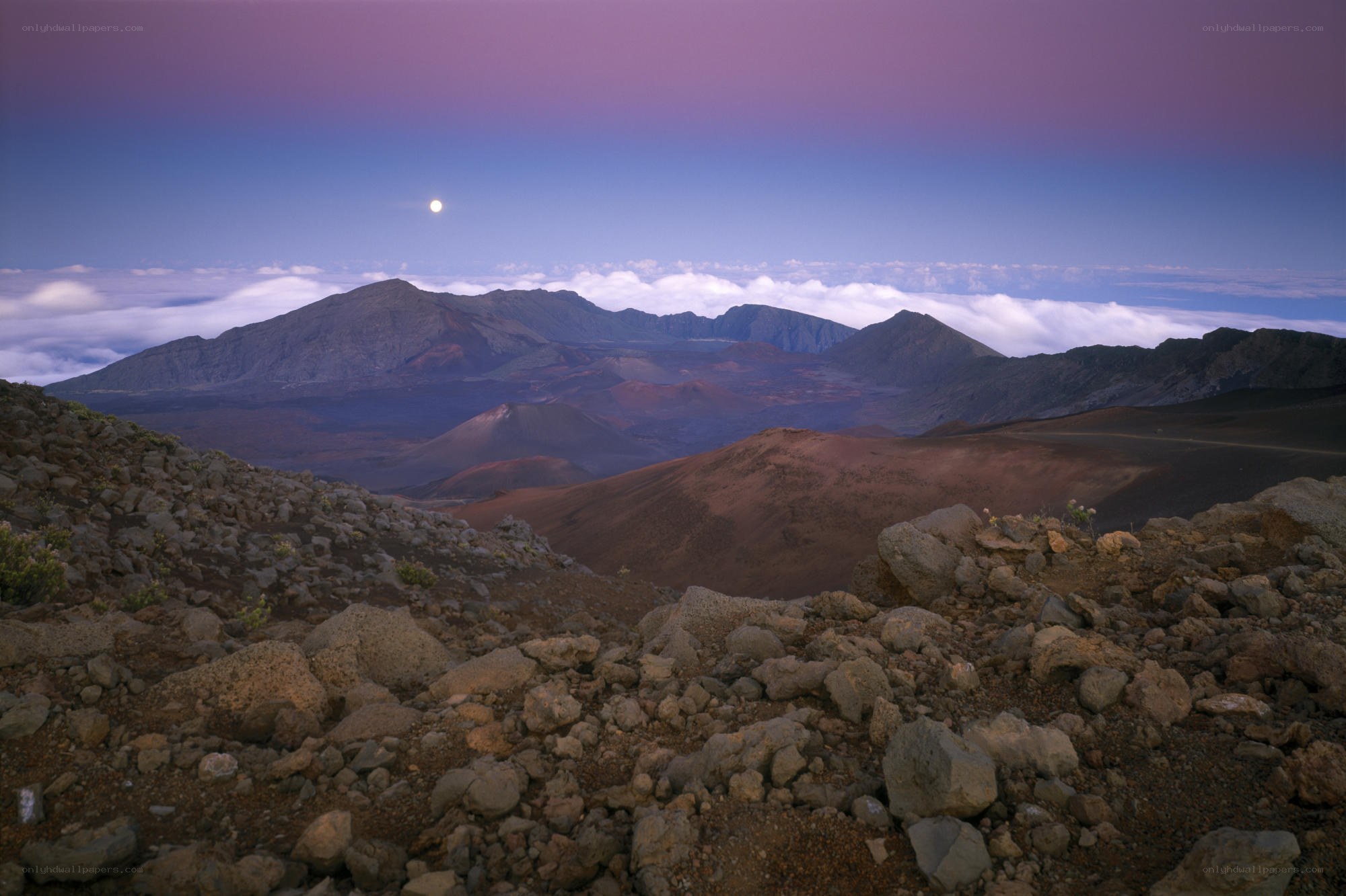 Moonrise over volcanic landscape