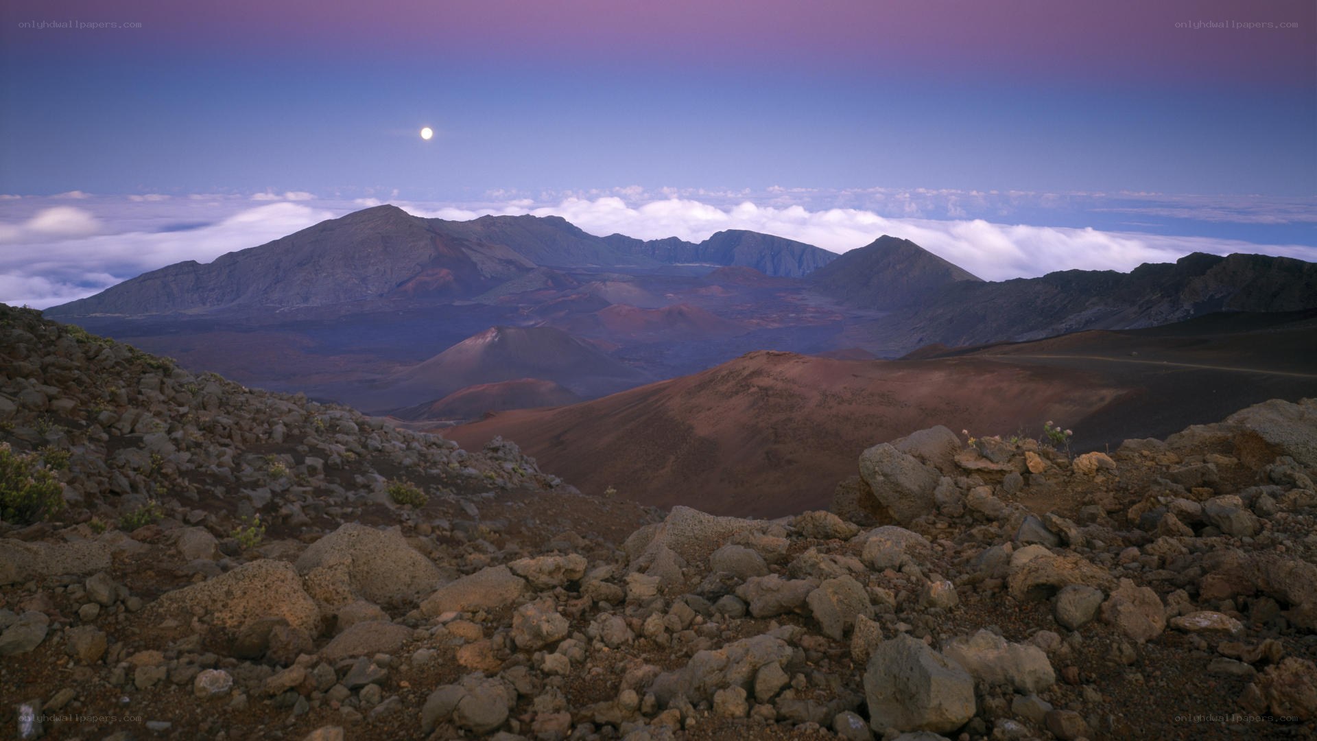 Moonrise over volcanic landscape