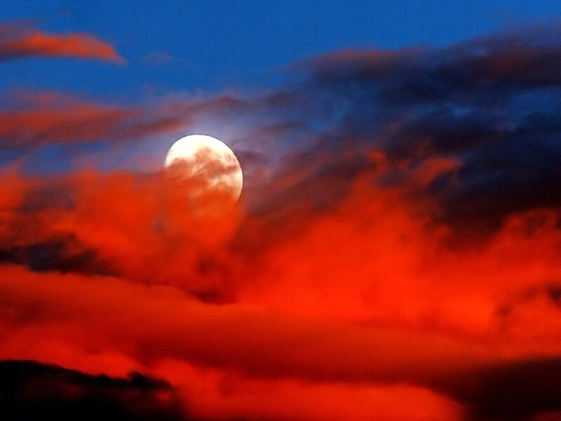 Moonrise through fiery clouds