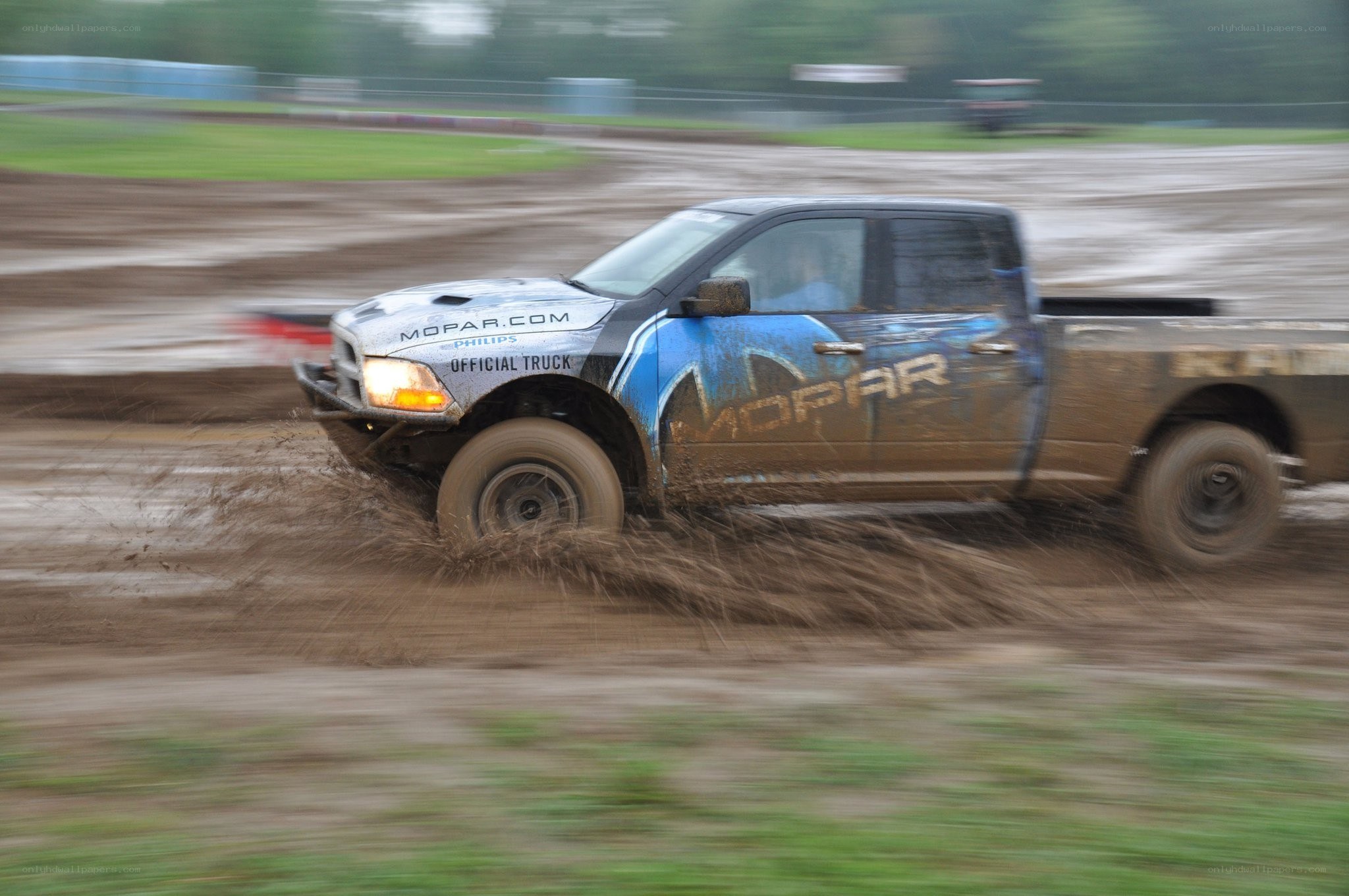 Mopar truck racing in mud