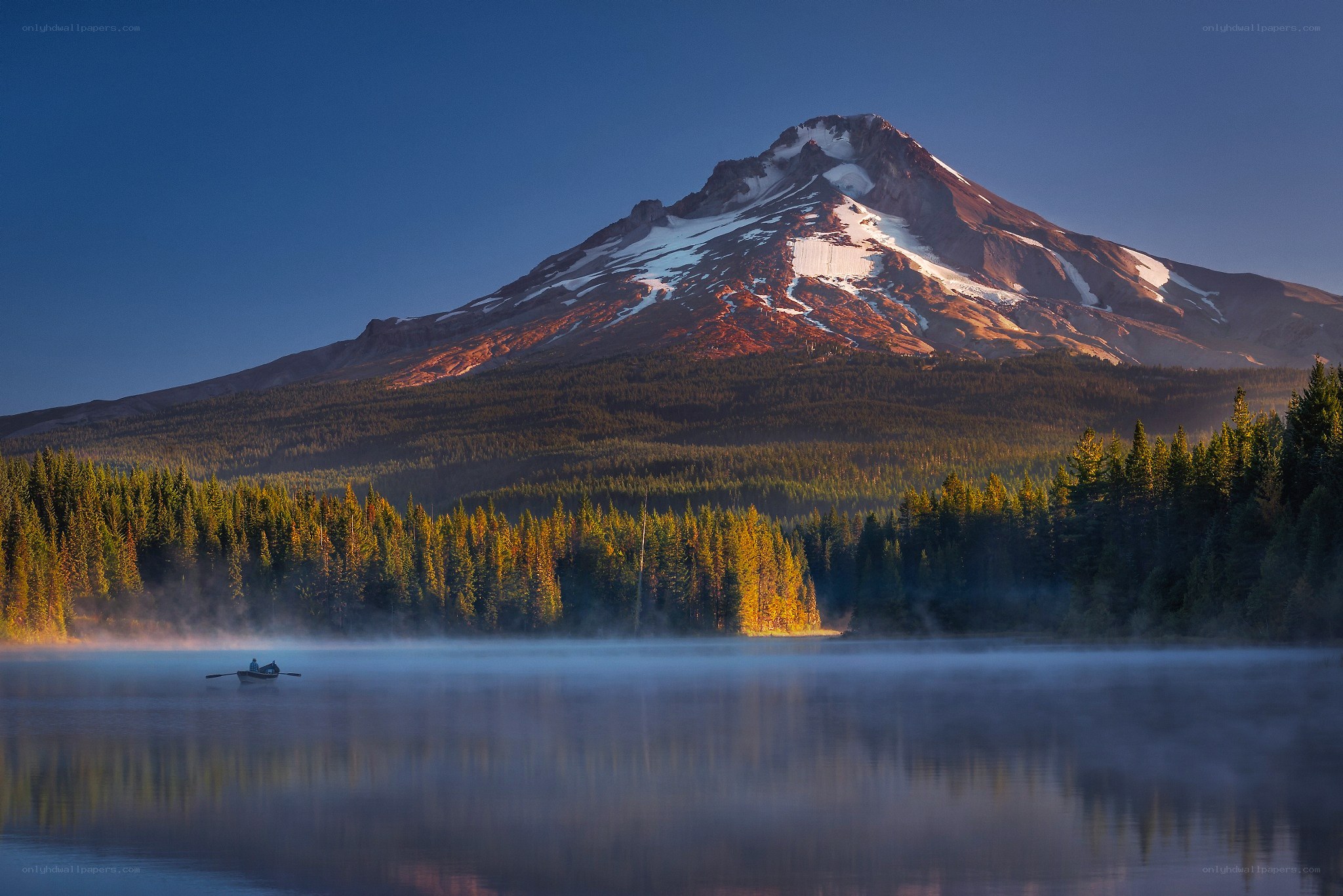 Morning mist on a lake with a mountain