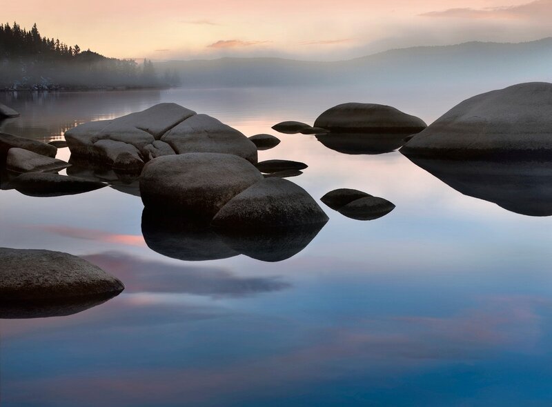 Morning mist over a calm lake
