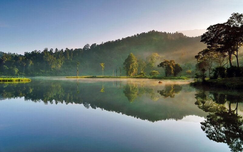 Morning mist over a calm lake