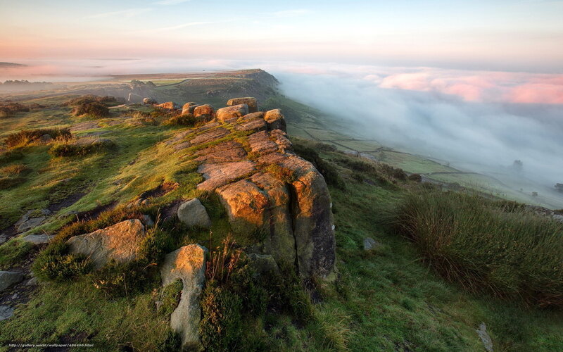 Morning mist over rocky hillside