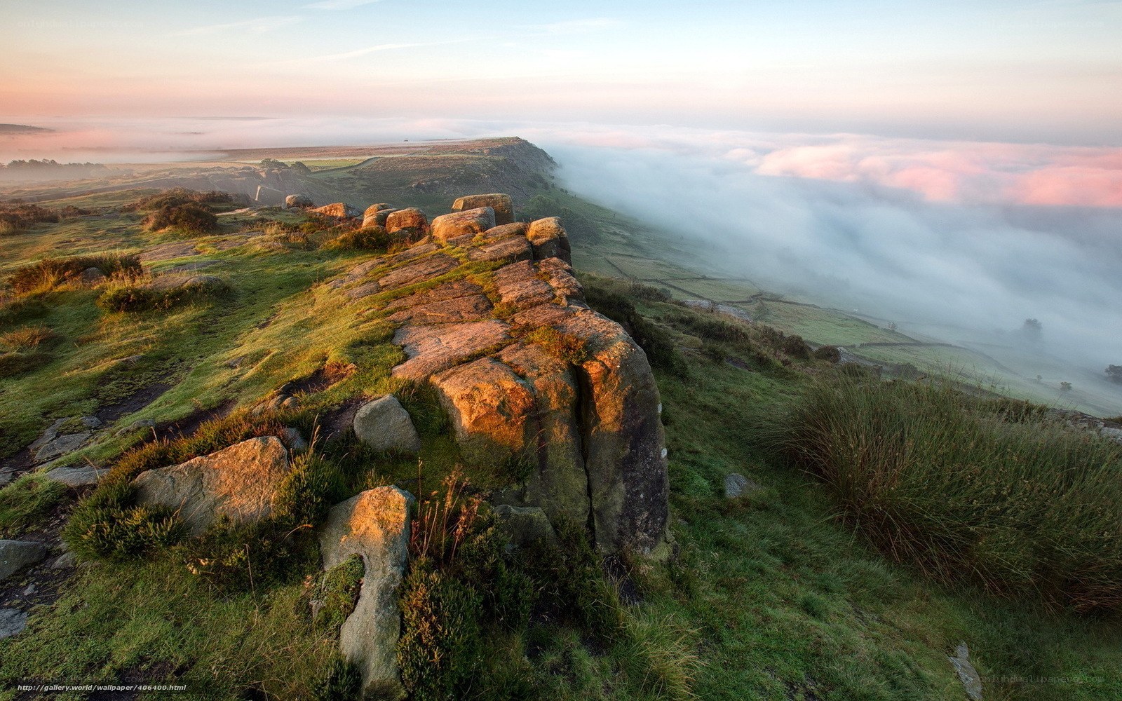 Morning mist over rocky hillside