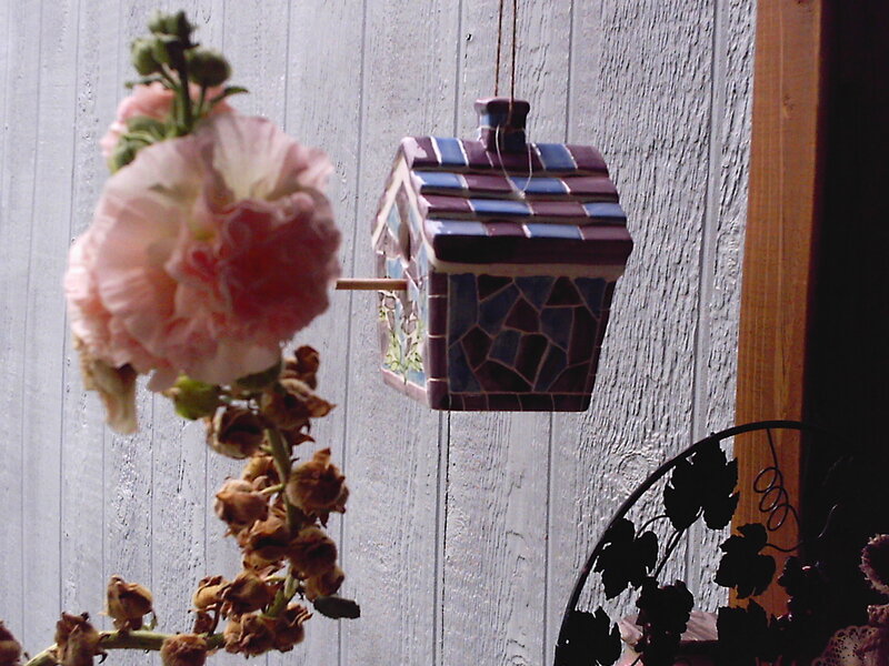 Mosaic birdhouse with hollyhock flower