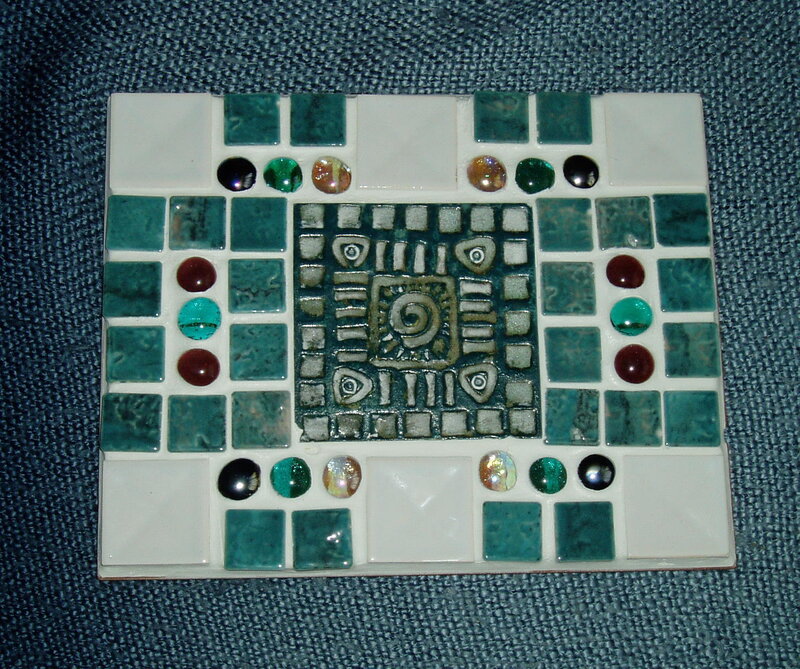 Mosaic tile artwork with central design